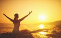 Yoga at sunset on beach. woman doing yoga