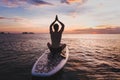 Yoga on SUP, silhouette of man sitting in lotus position on stand up paddle board Royalty Free Stock Photo