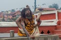 Yoga teacher with dreadlocks and beard showing exercise