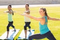 Yoga teacher and sporty women attending yoga class