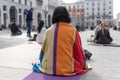 Yoga teachers protesting against the blockade and restrictions of Covid-19 in a square in Brescia, Italy. The people sitting on Royalty Free Stock Photo