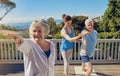 Yoga is their secret to staying young. a senior couple doing yoga together with an instructor on their patio outside. Royalty Free Stock Photo