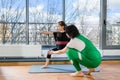 Yoga trainer teach child girl warrior pose