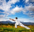 Yoga warrior pose in mountains Royalty Free Stock Photo