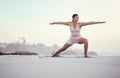 Yoga, warrior pose and woman on the beach doing a meditation for zen in nature. Sea, sand and young person with Royalty Free Stock Photo