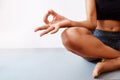 Yoga is what calms me. an unrecognizable woman practising yoga against a white background.