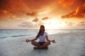 Yoga woman on beach at sunset Royalty Free Stock Photo