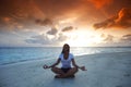 Yoga woman on beach at sunset Royalty Free Stock Photo