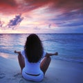 Yoga woman on beach at sunset Royalty Free Stock Photo