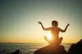 Yoga woman doing exercise on sea beach during sunset Royalty Free Stock Photo