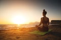 Yoga woman meditating at serene sunset or sunrise on the beach. The girl relaxes in the lotus position. Fingers folded Royalty Free Stock Photo