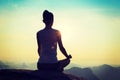 Yoga woman meditating on sunrise mountain peak Royalty Free Stock Photo