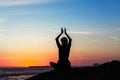 Yoga woman meditation silhouette on ocean coast. Royalty Free Stock Photo