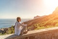 Yoga woman mountains. Profile of a woman doing yoga in the top of a cliff in the mountain. Woman meditates in yoga asana Royalty Free Stock Photo