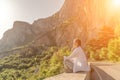 Yoga woman mountains. Profile of a woman doing yoga in the top of a cliff in the mountain. Woman meditates in yoga asana Royalty Free Stock Photo