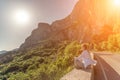 Yoga woman mountains. Profile of a woman doing yoga in the top of a cliff in the mountain. Woman meditates in yoga asana Royalty Free Stock Photo