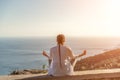 Yoga woman mountains. Profile of a woman doing yoga in the top of a cliff in the mountain. Woman meditates in yoga asana Royalty Free Stock Photo