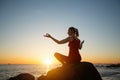 Yoga woman on the ocean coast during warm  sunset Royalty Free Stock Photo