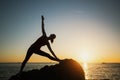 Yoga woman silhouette doing fitness exercises near the sea Royalty Free Stock Photo