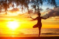 Yoga woman silhouette, exercises on the beach during a beautiful sunset Royalty Free Stock Photo