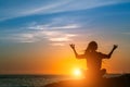 Yoga woman silhouette. Meditation on the Ocean during amazing sunset. Royalty Free Stock Photo