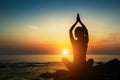 Yoga woman silhouette. Meditation on the ocean. Relax.