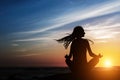 Yoga woman silhouette. Meditation on the ocean. Royalty Free Stock Photo