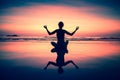 Yoga woman sitting on sea coast at surreal sunset. Meditation.