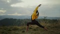 Yoga woman standing in warrior pose. Fit girl meditating in mountains Royalty Free Stock Photo