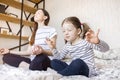 Yoga. Young woman and daughter doing yoga lotus position in bed. relaxation and meditation at home in isolation, to Royalty Free Stock Photo