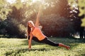 Yoga. Young woman practicing yoga or dancing or stretching in nature at park. Health lifestyle concept