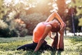 Yoga. mixed race woman practicing yoga or dancing or stretching in nature at park. Health lifestyle concept