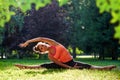 Yoga. mixed race woman practicing yoga or dancing or stretching in nature at park. Health lifestyle concept.