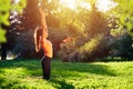 Yoga. Young woman practicing yoga or dancing or stretching in nature at park. Health lifestyle concept