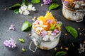 Yoghurt with granola, orange, mint and edible flowers Royalty Free Stock Photo