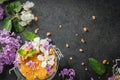 Yoghurt with granola, orange, mint and edible flowers Royalty Free Stock Photo