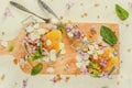 Yoghurt with granola, orange, mint and edible flowers Royalty Free Stock Photo