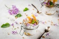 Yoghurt with granola, orange, mint and edible flowers Royalty Free Stock Photo