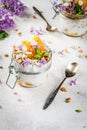 Yoghurt with granola, orange, mint and edible flowers Royalty Free Stock Photo