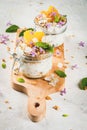 Yoghurt with granola, orange, mint and edible flowers Royalty Free Stock Photo