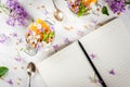 Yoghurt with granola, orange, mint and edible flowers Royalty Free Stock Photo