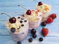 Yoghurt, oatmeal blueberry organic strawberry homemade dairy delicious refreshment apricot cherry on a blue wooden background