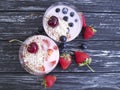 Yoghurt, strawberry, cherry, morning blueberry glass on a black wooden background