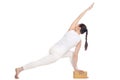Yogi female exercising with wood brick