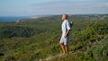 Yogi going green field at ocean view. Focused sportsman holding fitness mat Royalty Free Stock Photo