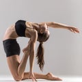 Yogi gymnast girl doing asana Ustrasana or Camel Pose