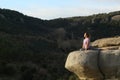 Yogi practicing yoga exercise in the top of a cliff in the mountain