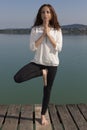 Yogi woman doing tree pose outdoors in nature