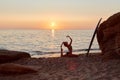 Yogi woman practicing yoga on seashore. Meditation idea. One Legged King Pigeon exercise. Eka Pada Rajakapotasana pose. Royalty Free Stock Photo