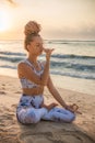 Yogi woman sitting in lotus pose, practicing Anuloma Viloma Pranayama, Alternate Nostril Breathing. Control prana, control of Royalty Free Stock Photo